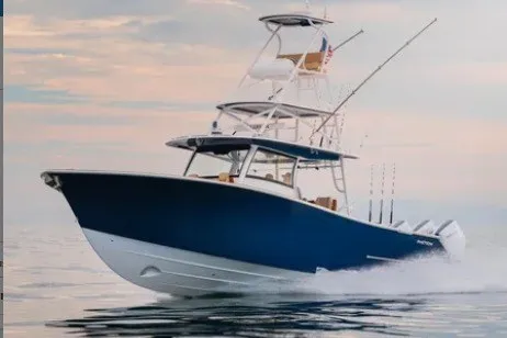 The Image of 2027 Phenom 43 Center Console boat cruising on calm waters at sunset. - 0