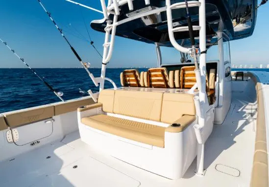 Slide: The Image of 2026 Phenom 43 Center Console boat with beige seating, ocean backdrop. - 6