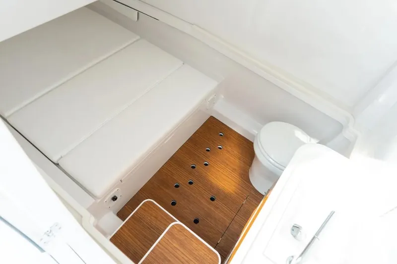 Slide: The Image of Interieur van een Phenom 37 Center Console uit 2027 met houten vloer en toilet. - 10