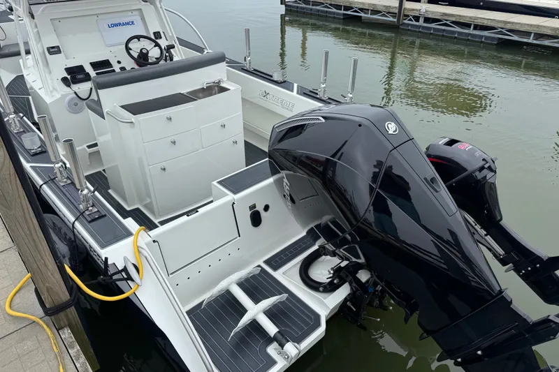 Slide: The Image of 2021 Extreme Boats 745 Center Console 24' with powerful outboard motor docked at marina. - 6