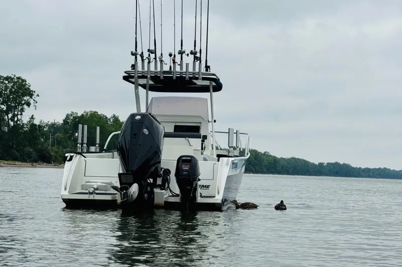 Slide: The Image of 2021 Extreme Boats 745 Center Console 24' on calm water with fishing rods. - 3