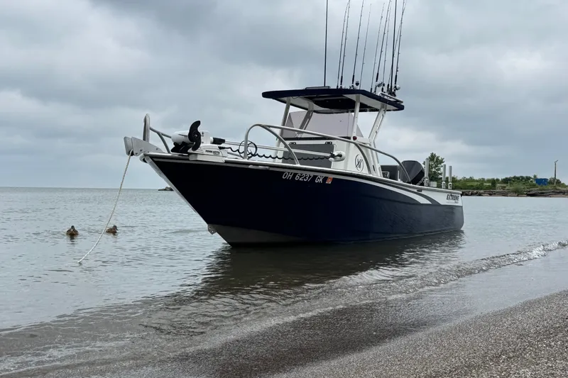 Slide: The Image of 2021 Extreme Boats 745 Center Console 24' anchored on a calm shoreline. - 4
