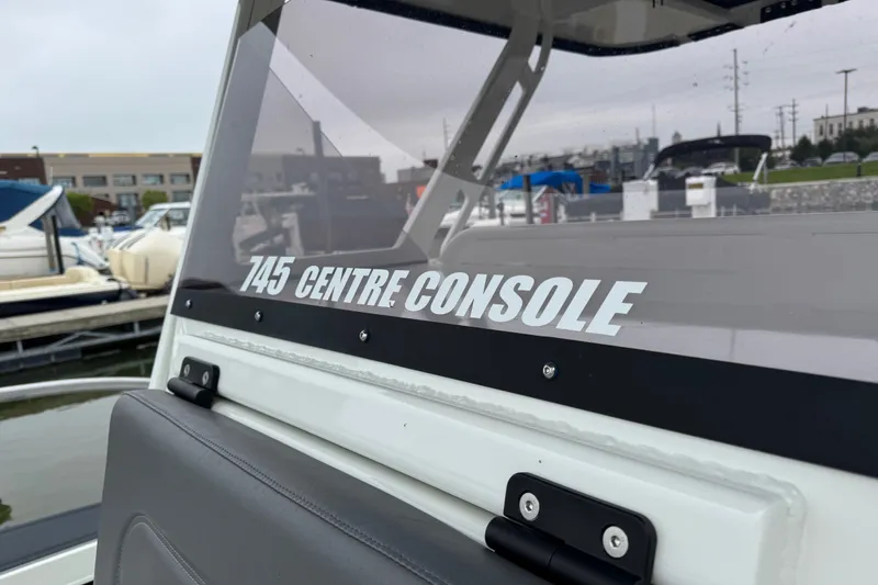 Slide: The Image of 2021 Extreme Boats 745 Center Console at marina, showcasing sleek design and branding. - 18