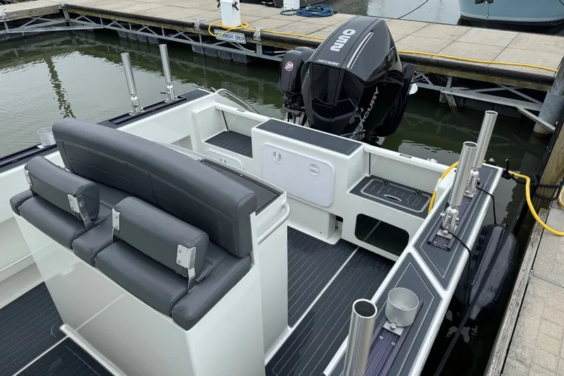 Slide: The Image of 2021 Extreme Boats 745 Center Console 24' at dock, featuring sleek seating and powerful outboard motor. - 10