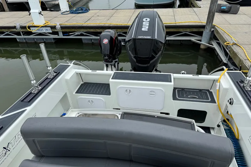 Slide: The Image of 2021 Extreme Boats 745 Center Console 24' at dock, featuring Mercury outboard engine. - 14