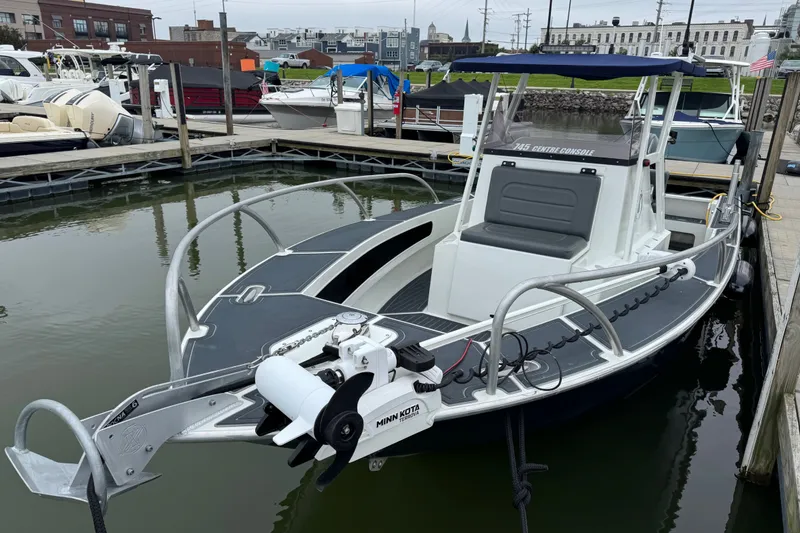 Slide: The Image of 2021 Extreme Boats 745 Center Console 24' docked, featuring sleek design and modern equipment. - 12