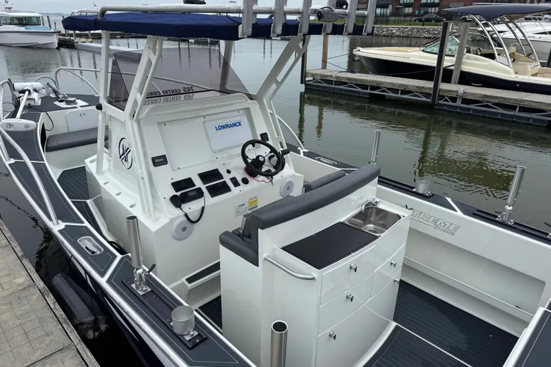 Slide: The Image of 2021 Extreme Boats 745 Center Console 24' docked, featuring modern navigation equipment and sleek design. - 8