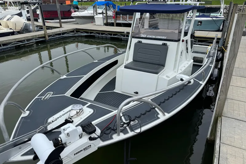 Slide: The Image of 2021 Extreme Boats 745 Center Console 24' docked, featuring sleek design and modern amenities. - 13