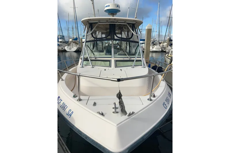 Slide: The Image of 1996 Grady-White Gulfstream 232 boat docked in a marina, front view. - 6