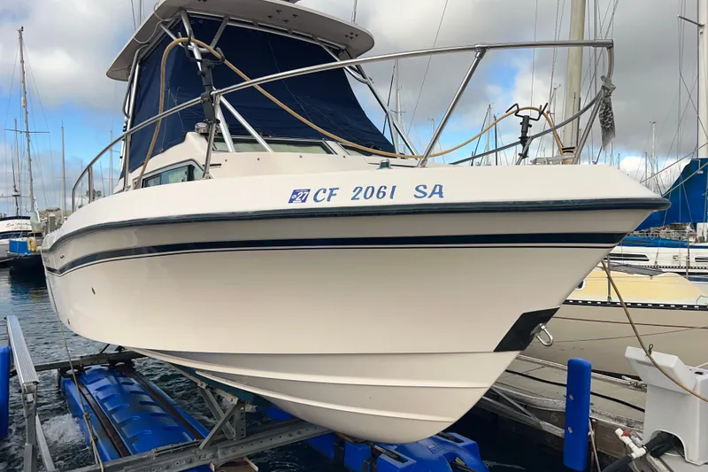 Slide: The Image of 1996 Grady-White Gulfstream 232 boat docked at a marina, front view. - 10