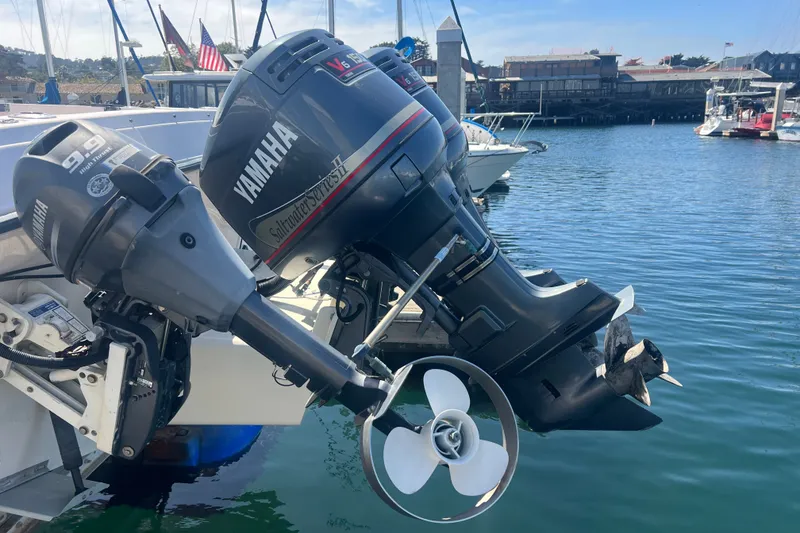 Slide: The Image of Outboard motors on a 1996 Grady-White Gulfstream 232 boat docked in a marina. - 24