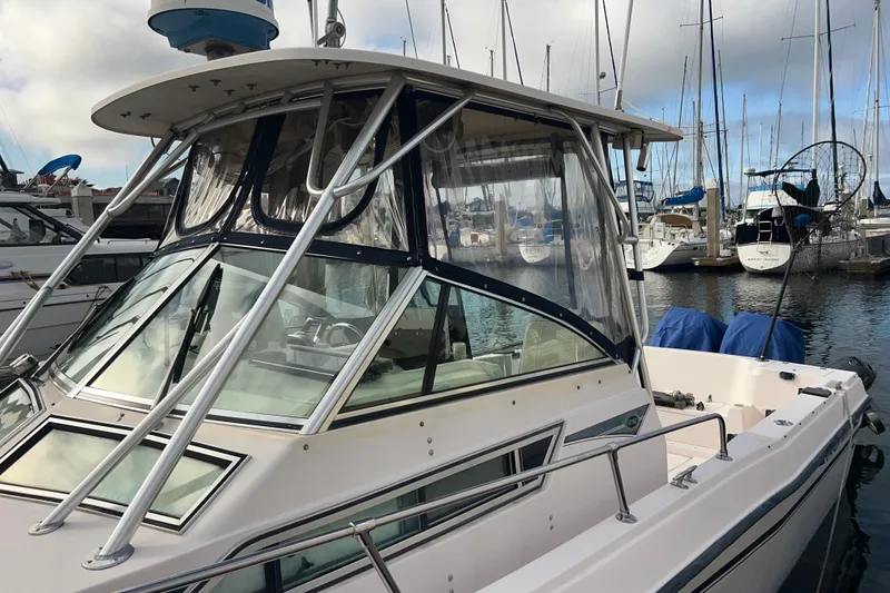 Slide: The Image of 1996 Grady-White Gulfstream 232 boat docked in marina with clear enclosure. - 1