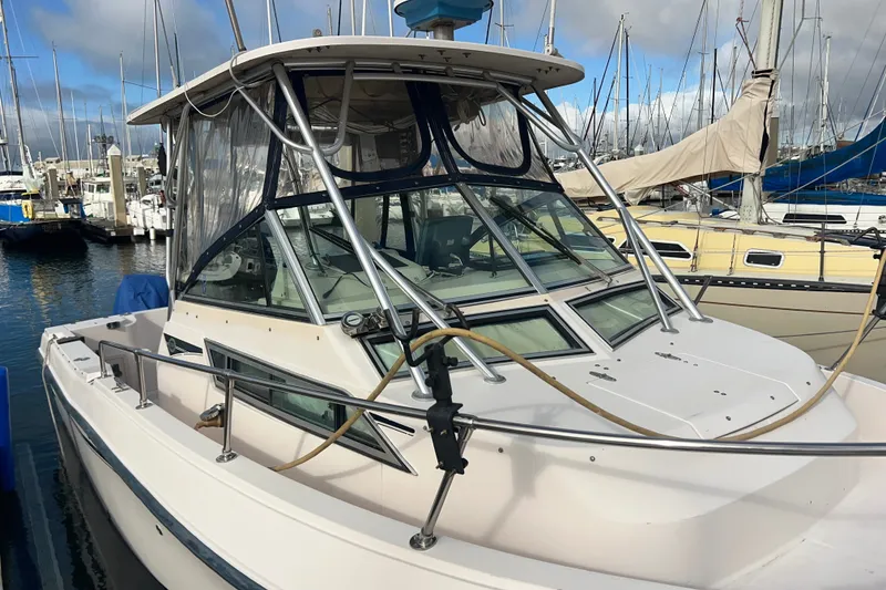 Slide: The Image of 1996 Grady-White Gulfstream 232 boat docked at marina with sailboats. - 2
