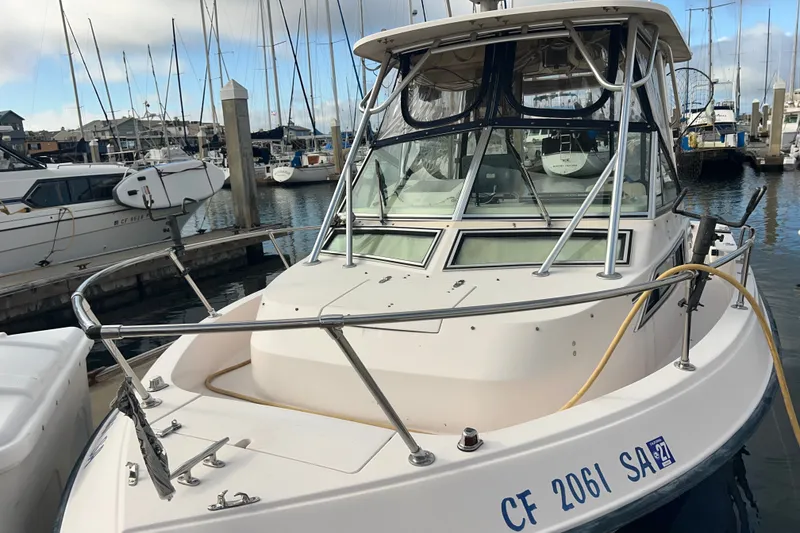 Slide: The Image of 1996 Grady-White Gulfstream 232 boat docked at marina with other vessels. - 4