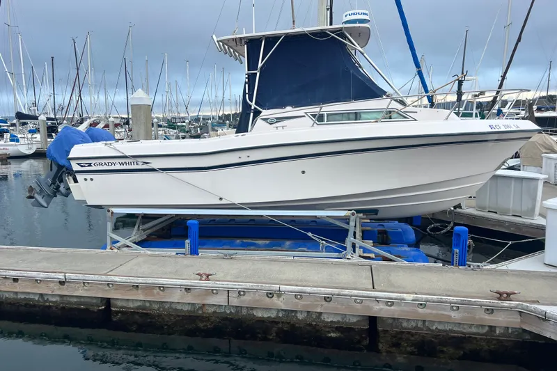 Slide: The Image of 1996 Grady-White Gulfstream 232 boat docked at marina, side view. - 13