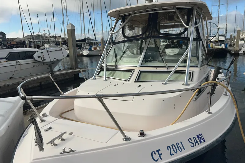 Slide: The Image of 1996 Grady-White Gulfstream 232 boat docked at marina with other vessels. - 5