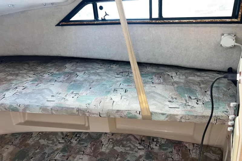 Slide: The Image of 1996 Grady-White Gulfstream 232 cabin interior with patterned upholstery and window. - 16