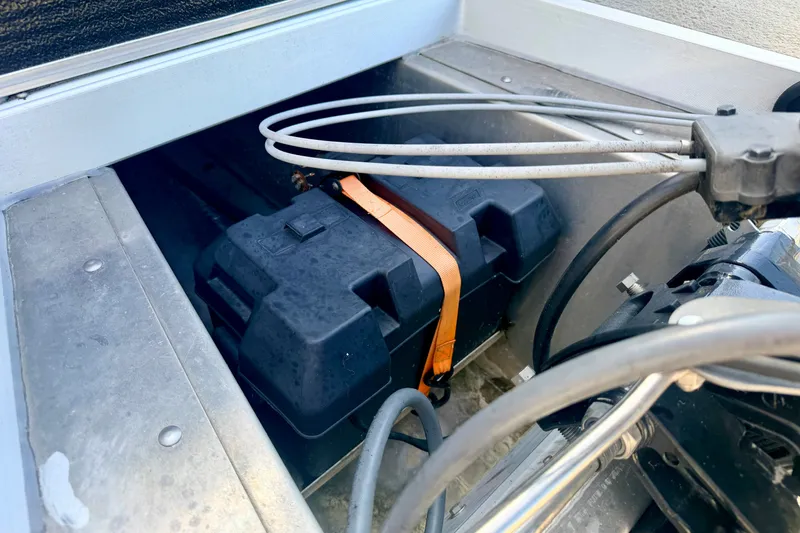 Slide: The Image of Battery compartment of 2011 Palm Beach Sport Fish 1623 SE boat with cables and straps. - 20