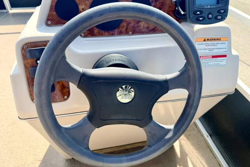 Slide: The Image of Steering wheel of 2011 Palm Beach Sport Fish 1623 SE boat, featuring control panel. - 36