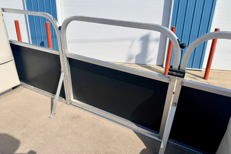 Slide: The Image of 2011 Palm Beach Sport Fish 1623 SE boat railing and deck, outdoor setting. - 46