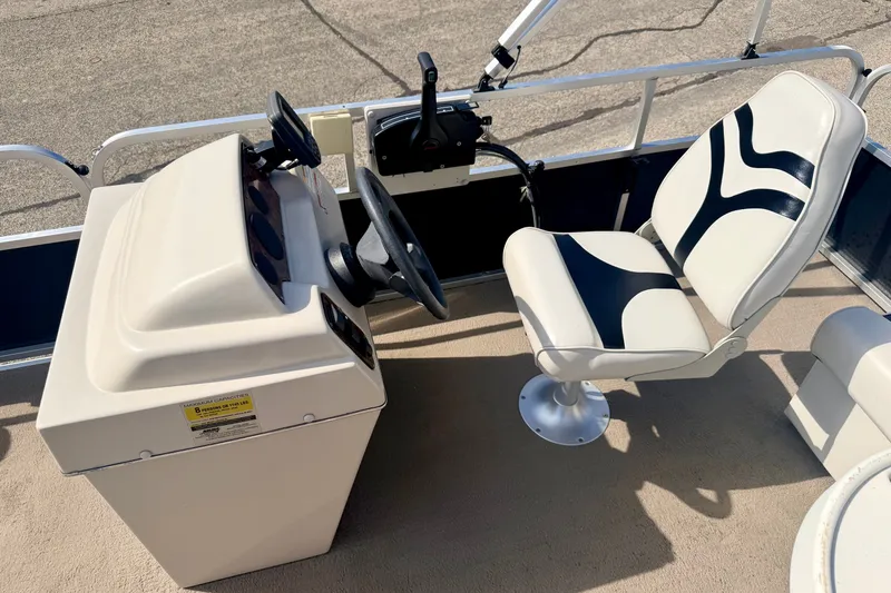 Slide: The Image of 2011 Palm Beach Sport Fish 1623 SE boat cockpit with steering wheel and stylish captain's chair. - 31