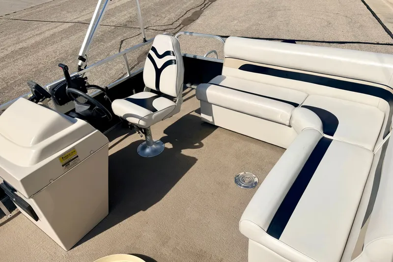 Slide: The Image of 2011 Palm Beach Sport Fish 1623 SE boat interior with white seating and steering console. - 22