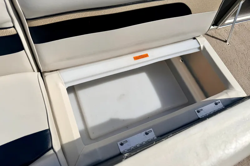 Slide: The Image of Open storage compartment on 2011 Palm Beach Sport Fish 1623 SE boat seat. - 29