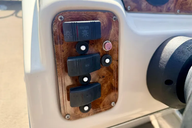 Slide: The Image of Control panel of 2011 Palm Beach Sport Fish 1623 SE boat with switches and knobs. - 35