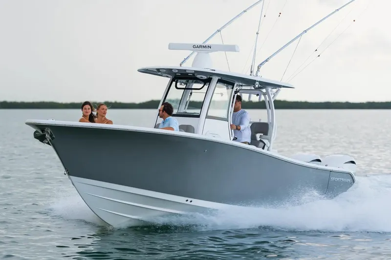 Slide: The Image of 2026 Sportsman Open 282 Center Console boat cruising on water with passengers. - 1