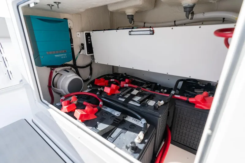 Slide: The Image of 2026 Sportsman Open 282 Center Console battery compartment with wiring and electrical components. - 14