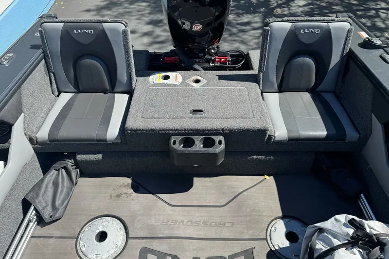 Slide: The Image of 2021 Lund 1775 Crossover XS boat interior with dual seats and storage compartments. - 15