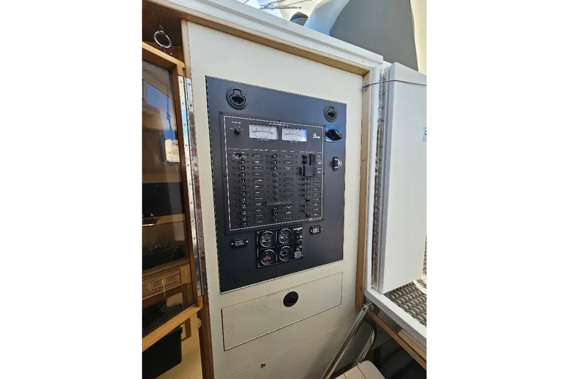 Slide: The Image of Electrical panel of a 2000 Albin 31 Tournament Express boat, featuring switches and gauges. - 17