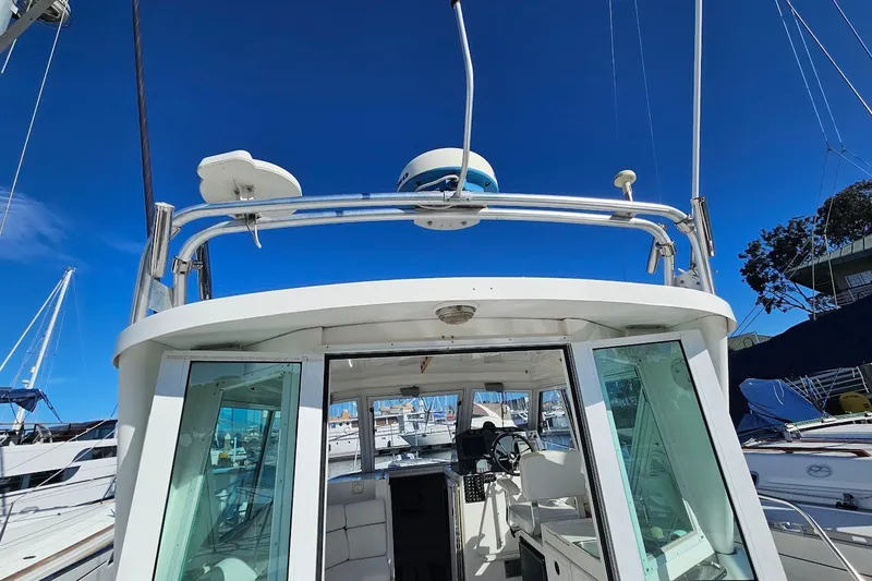 Slide: The Image of 2000 Albin 31 Tournament Express boat with open cabin and clear blue sky background. - 9