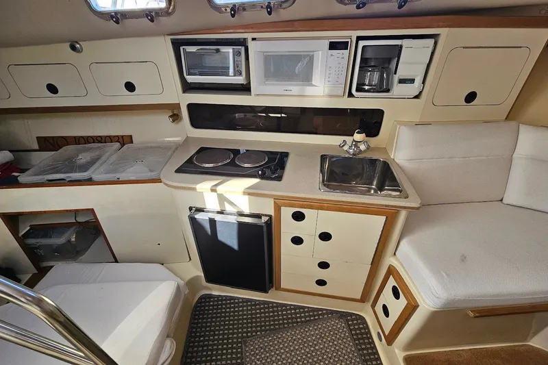 Slide: The Image of Interior of 2000 Albin 31 Tournament Express boat with kitchenette and seating area. - 20