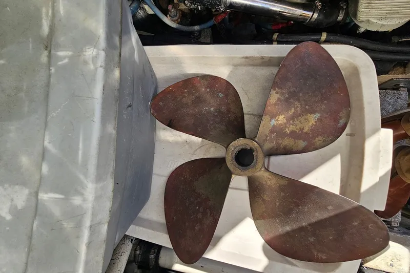 Slide: The Image of Rustic boat propeller from a 2000 Albin 31 Tournament Express, resting on a white surface. - 29