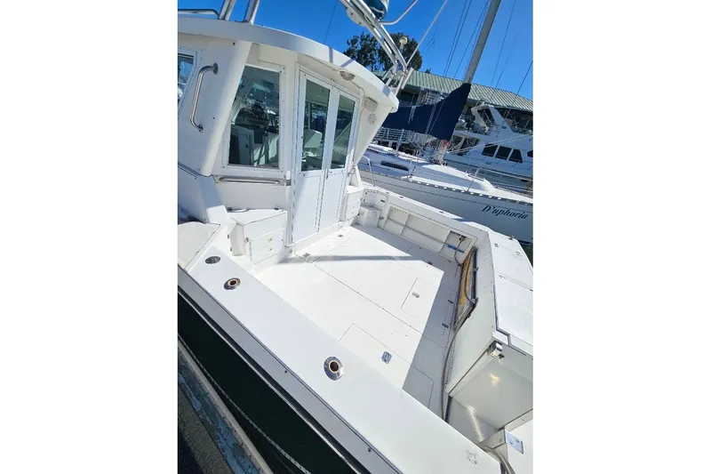 Slide: The Image of 2000 Albin 31 Tournament Express boat with spacious deck and cabin, docked at marina. - 5