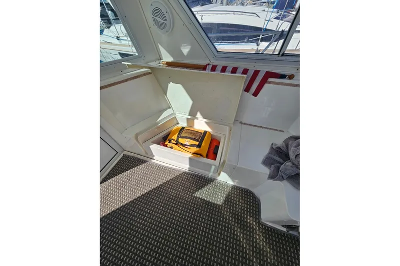 Slide: The Image of Interior of 2000 Albin 31 Tournament Express boat with storage compartment open. - 14
