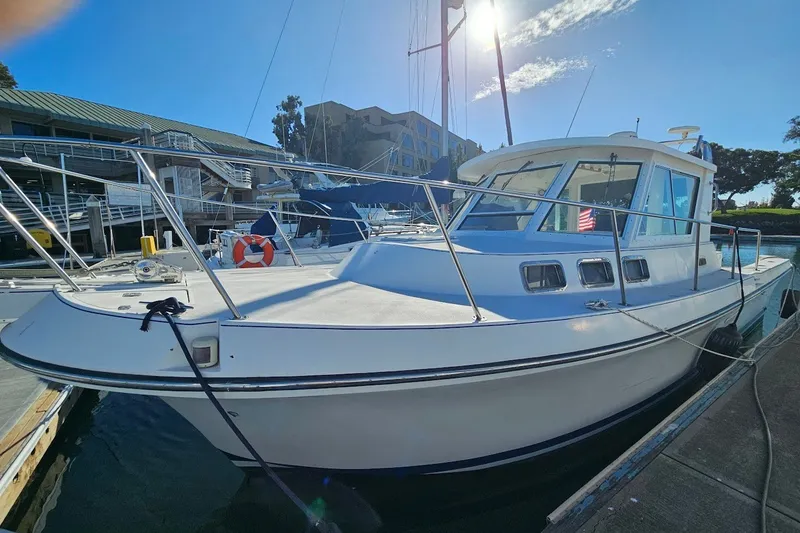 Slide: The Image of 2000 Albin 31 Tournament Express boat docked at marina under clear blue sky. - 2