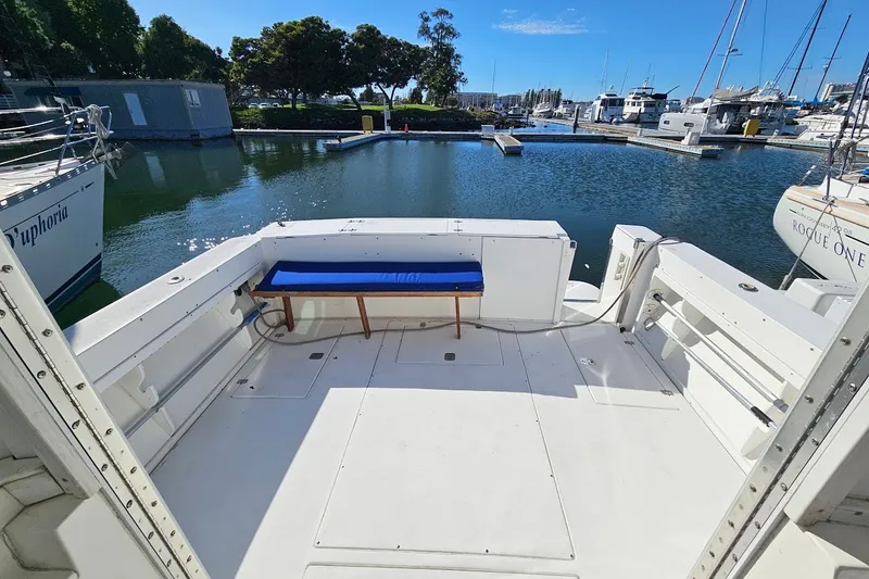 Slide: The Image of 2000 Albin 31 Tournament Express boat deck at marina, featuring spacious seating and scenic water view. - 6