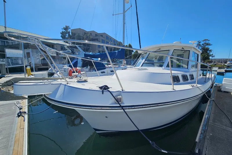 Slide: The Image of 2000 Albin 31 Tournament Express boat docked at marina under clear blue sky. - 1