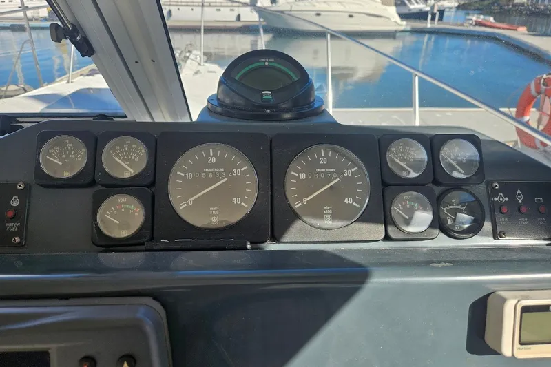 Slide: The Image of Dashboard of a 2000 Albin 31 Tournament Express boat with various gauges and controls. - 15