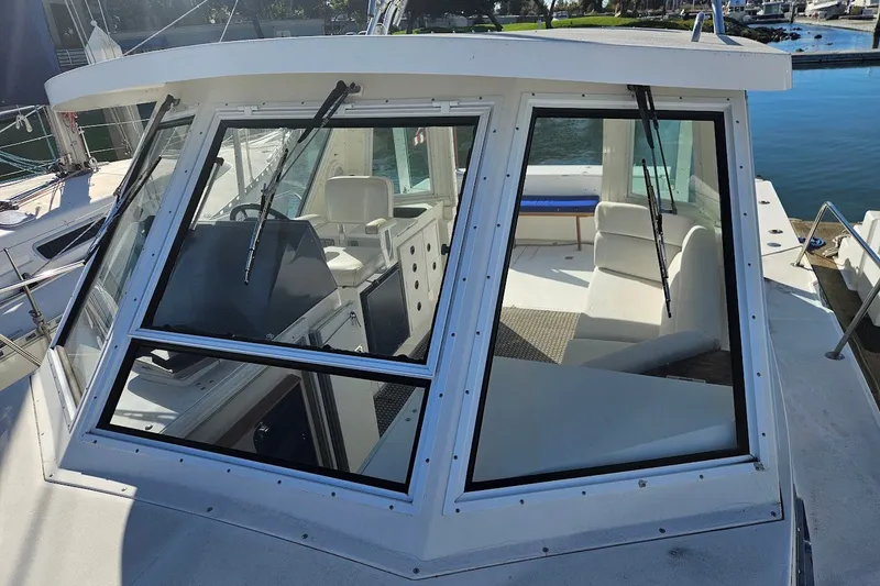 Slide: The Image of 2000 Albin 31 Tournament Express boat cockpit with clear windows and marina view. - 4