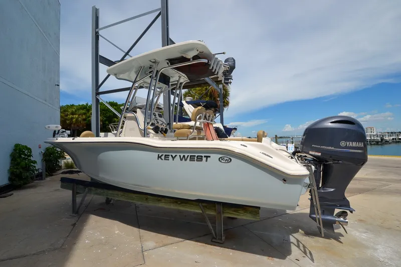 Slide: The Image of A 2018 Key West 219 FS boat is on a dry dock. It features a Yamaha outboard motor. - 26