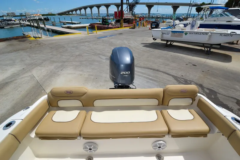 Slide: The Image of The image shows the stern of a Key West 219 FS boat with an outboard motor. - 28