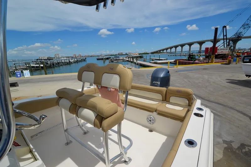 Slide: The Image of A 2018 Key West 219 FS boat docked with a view of a bridge in the background. - 11