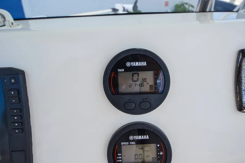 Slide: The Image of Two Yamaha gauges on a boat panel display tachometer and speed readings. - 30