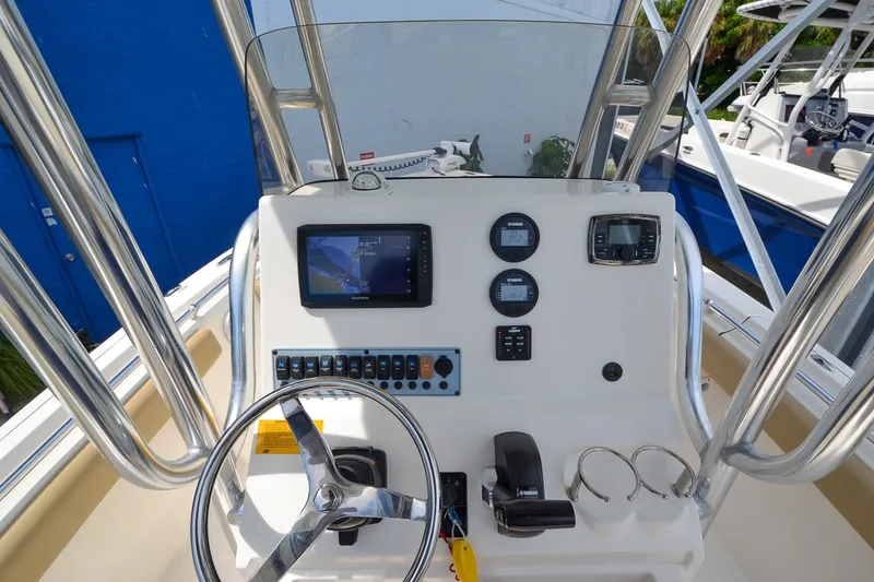 Slide: The Image of The image shows the helm of a Key West 219 FS boat with various instruments and a screen. - 20