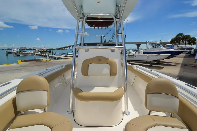 Slide: The Image of The image shows the cockpit of a 2018 Key West 219 FS boat with beige seating. - 1