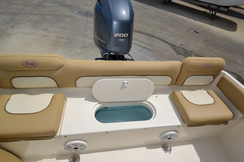 Slide: The Image of The image shows the cockpit of a 2018 Key West 219 FS boat with beige seating. - 16