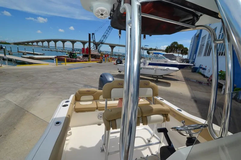 Slide: The Image of A 2018 Key West 219 FS boat is docked, with a view of a bridge in the background. - 17